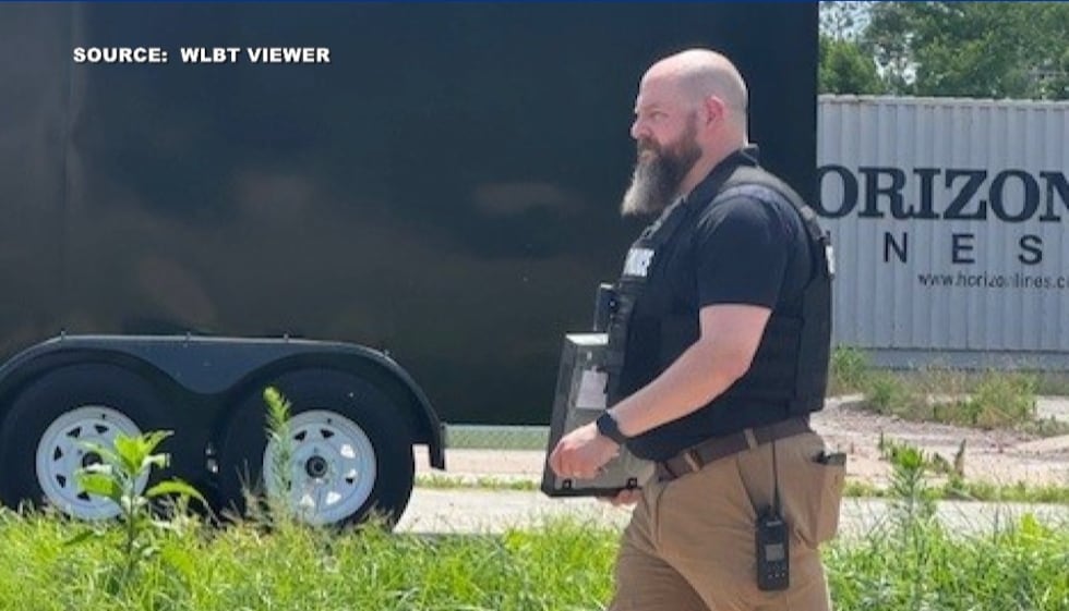 An officer is seen by taking a computer from the Town Hall of Rolling Fork.