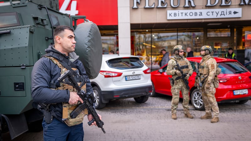 Police officers are seen at the site where a gunman killed at least six people in the streets...