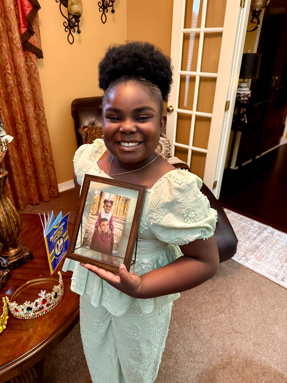 Carsyn holds a photo of her and her brother, Jacob, from a few years ago.